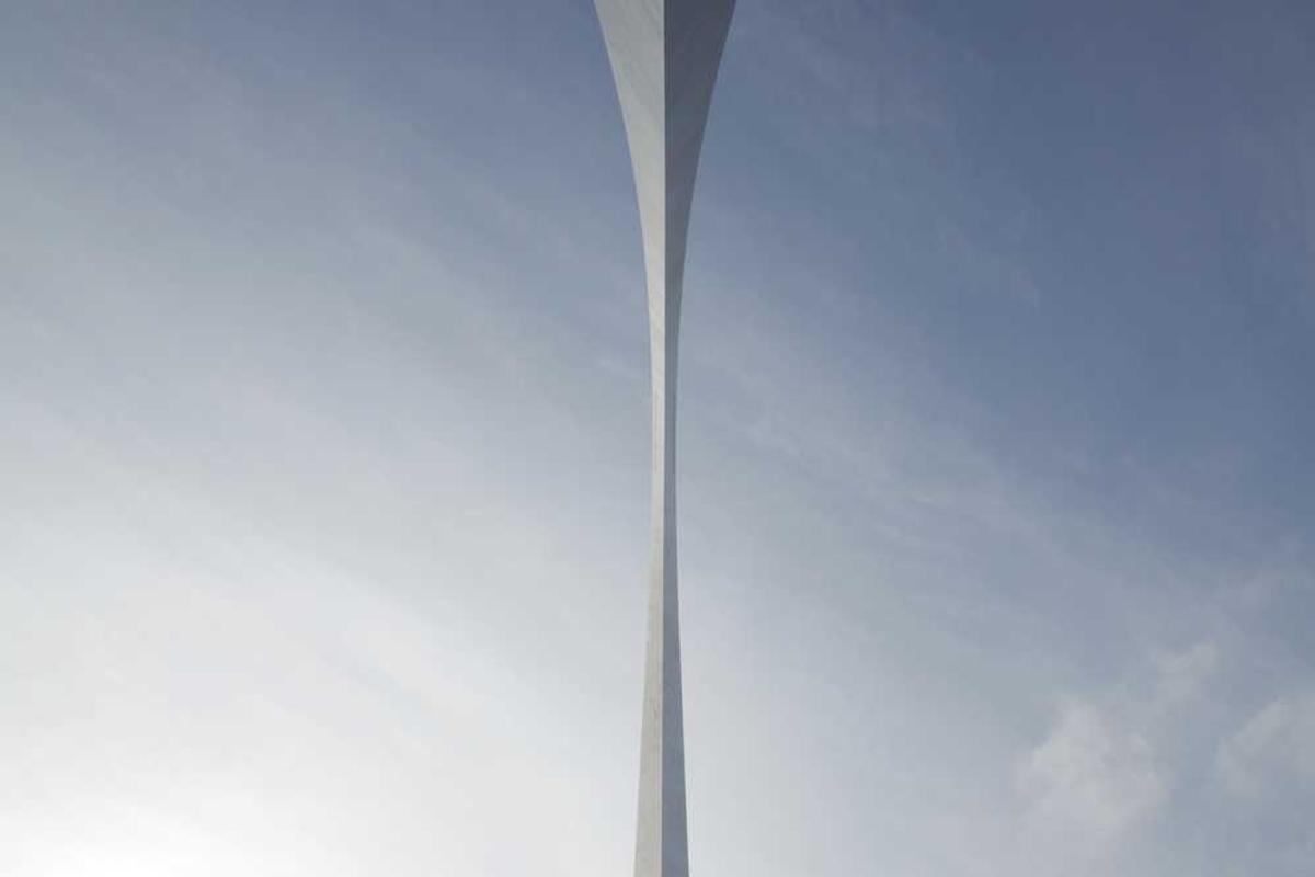 Busy professional working remotely at a cluttered home office with a Hanamori height adjustable desk