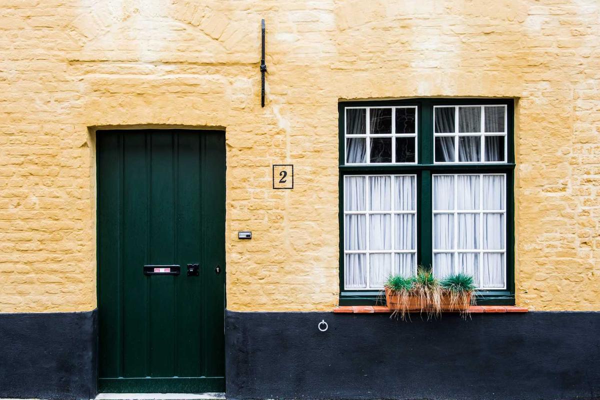 Person working at a clutter-free home office with a laptop table and organized storage