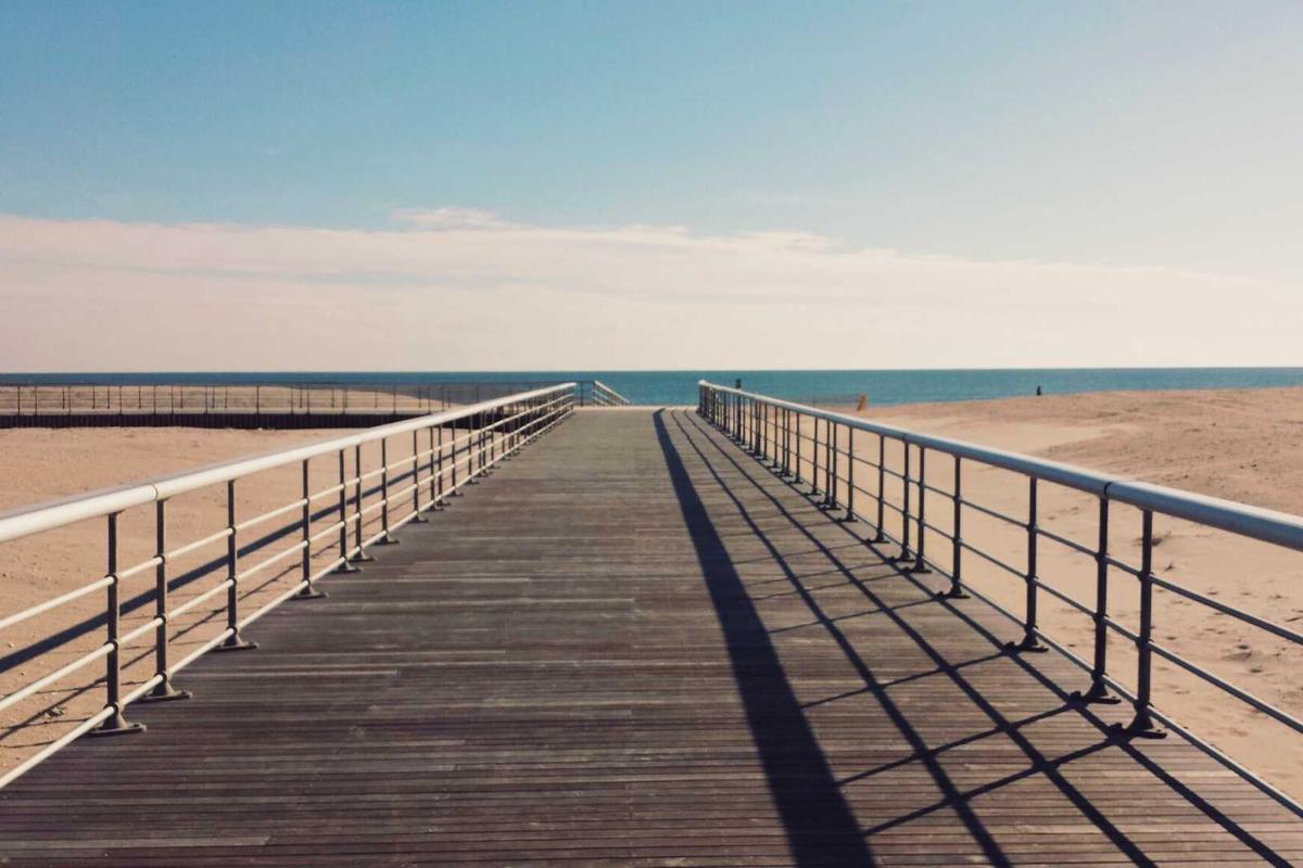 5 Space-Saving Wisdoms: Floating Shelf vs Standing Desk Converter - Which is Best for Your Tiny Home? Person using standing desk converter in tiny home workspace with ergonomic setup